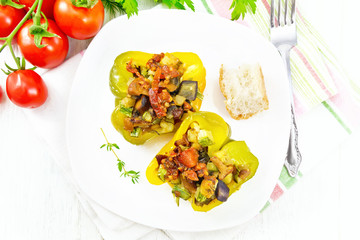 Pepper stuffed with vegetables in plate on light board top