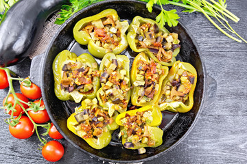 Pepper stuffed with vegetables in pan on board top