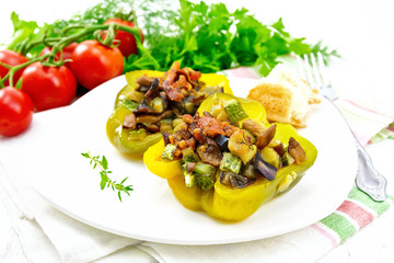 Pepper stuffed with vegetables in plate on light board