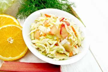 Salad of cabbage and rhubarb in plate on light board