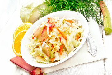 Salad of cabbage and rhubarb in plate on white board
