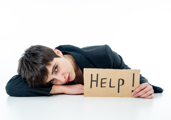 Beautiful young business woman overwhelmed and desperate holding a help sign