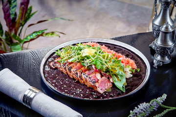 Modern cuisine. Rare Roast beef with green leaf of salad and grapefruit. Warm salad for lunch. Healthy food. Baked meat. Close up. Horizontal. Copy space