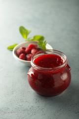 Homemade raspberry jam with fresh mint