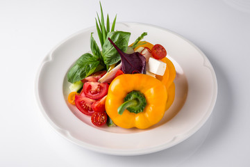 Snack from fresh vegetables and cheese. Tomatoes, cucumbers, peppers, onions. Banquet festive dishes. Gourmet restaurant menu. White background.