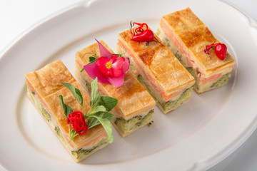 Quiche, casserole, delicious omelet from eggs, cheese, salmon, broccoli, spinach, pate. Banquet festive dishes. Gourmet restaurant menu. White background.