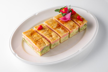 Quiche, casserole, delicious omelet from eggs, cheese, salmon, broccoli, spinach, pate. Banquet festive dishes. Gourmet restaurant menu. White background.