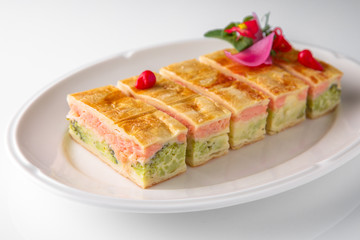 Quiche, casserole, delicious omelet from eggs, cheese, salmon, broccoli, spinach, pate. Banquet festive dishes. Gourmet restaurant menu. White background.