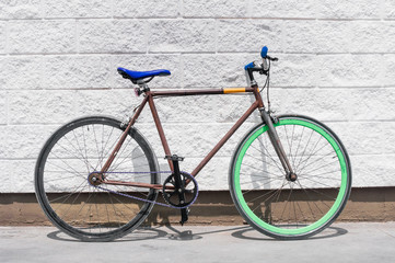 Fototapeta na wymiar Old fixed gear bicycle on white wall background