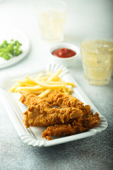 Homemade fish and chips on white plate