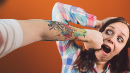 The man hit the woman. A man's fist hits a woman in the face. Interpersonal conflict and violence...