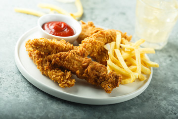 Homemade fish and chips on white plate
