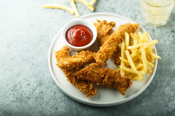 Homemade fish and chips on white plate