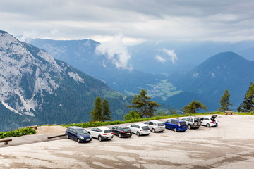 Fototapeta na wymiar Cars parking under alpine mountain in Austria