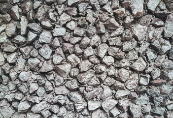 Old stone of wall texture. Lots of granite cobblestones.