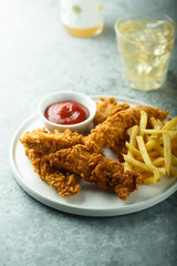 Homemade fish and chips on white plate
