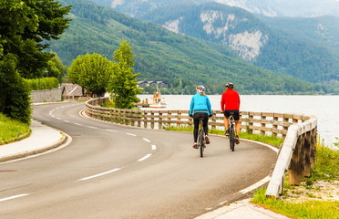 Fototapeta premium Road along the mountain lake. Summer evening. Austrian Alps.