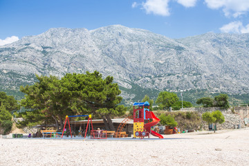 playground on the beach in the village of Baska Voda, Makarska Riviera, Adriatic Coast, Croatia, Europe