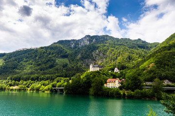 Castle Klaus on the blue lake in Austrian Alps. Summer day.