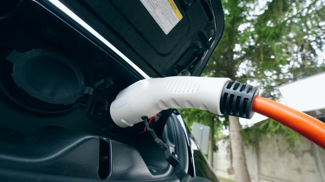 A person launches recharging process of an electrocar