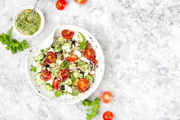 mediterranean couscous salad with fried cherry tomatoes, cucumber