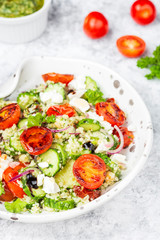 mediterranean couscous salad with fried cherry tomatoes, cucumber