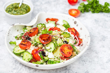 mediterranean couscous salad with fried cherry tomatoes, cucumber