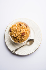 Traditional Jaggery Rice or Gur wale chawal in Hindi, served in a bowl with spoon. selective focus