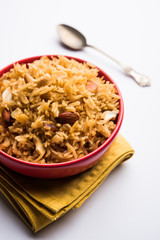 Traditional Jaggery Rice or Gur wale chawal in Hindi, served in a bowl with spoon. selective focus