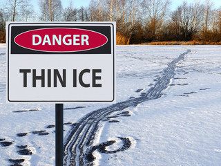 sign danger thin ice and footprints road on snow and ice