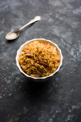 Traditional Jaggery Rice or Gur wale chawal in Hindi, served in a bowl with spoon. selective focus