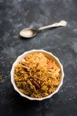 Traditional Jaggery Rice or Gur wale chawal in Hindi, served in a bowl with spoon. selective focus
