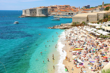DUBROVNIK, CROATIA - JULY 12, 2019: Aerial view of Dubrovnik old town and Banje beach, Adriatic sea