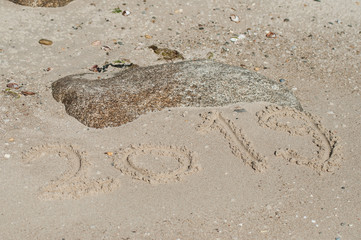 closeup of 2019 writing in the sand on the beach