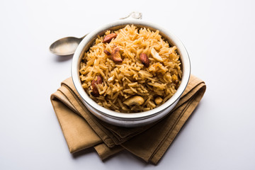 Traditional Jaggery Rice or Gur wale chawal in Hindi, served in a bowl with spoon. selective focus