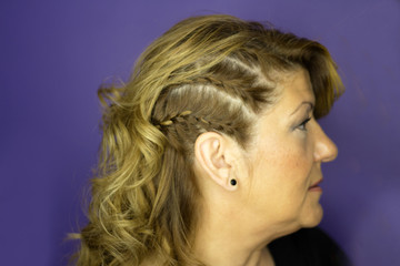 Woman with wavy blond hair and braids