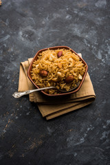 Traditional Jaggery Rice or Gur wale chawal in Hindi, served in a bowl with spoon. selective focus