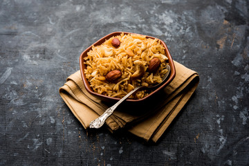 Traditional Jaggery Rice or Gur wale chawal in Hindi, served in a bowl with spoon. selective focus