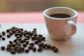 Cup filled with coffee beans.