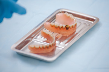 Close-up an acrylic denture prosthesis of the upper and lower jaws of a man