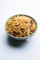 Traditional Jaggery Rice or Gur wale chawal in Hindi, served in a bowl with spoon. selective focus