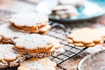 Freshly baked sandwich cookies filled with caramelized milk and coconut