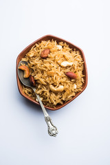 Traditional Jaggery Rice or Gur wale chawal in Hindi, served in a bowl with spoon. selective focus