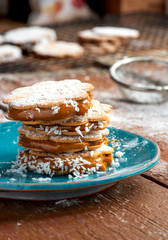Freshly baked sandwich cookies filled with caramelized milk and coconut