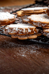 Freshly baked sandwich cookies filled with caramelized milk and coconut