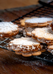 Freshly baked sandwich cookies filled with caramelized milk and coconut