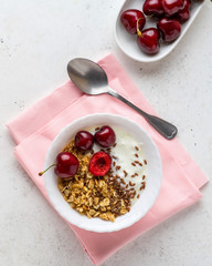 Healthy breakfast with greek yogurt, granola (muesli), flax seeds, cherries. Health care, fitness,...