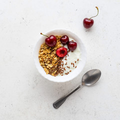 Healthy breakfast with greek yogurt, granola (muesli), flax seeds, cherries. Health care, fitness,...