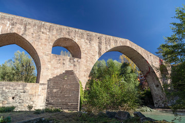 Fototapeta na wymiar Sant Joan de les Abadesses, Catalonia, Spain. Old bridge, Pont Vell.