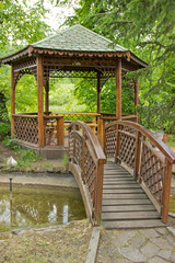 Fototapeta premium summer house with a bridge over the stream